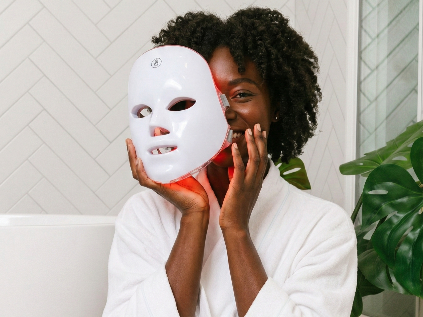 The GLOKORE Wireless LED Light Therapy Mask sits perfectly centered on a matte black background with a single spotlight above it — clean, dramatic, and evokes clarity in chaos.